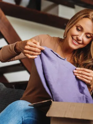 Smiling customer receiving a package at home