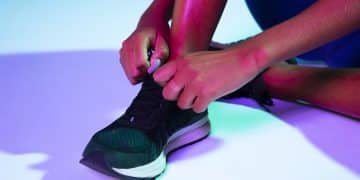 close-up-athlete-tying-her-shoes